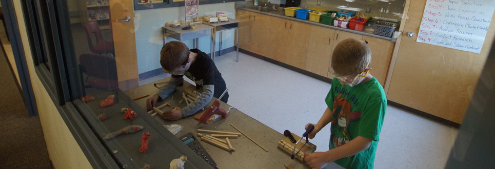 Two male students working on a woodworking project in the Markerspace of the Learning Commons